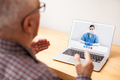 Young NHS GP physician and elderly male patient consulting over video call technology - PhotoDune Item for Sale