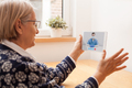 Elderly caucasian woman talking to young female UK e-doctor via online video chat - PhotoDune Item for Sale