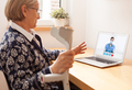 Retired senior elderly woman talking to GP female doctor via virtual telemedicine video call - PhotoDune Item for Sale