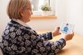 Retired senior elderly woman talking to GP physician via virtual telemedicine video call - PhotoDune Item for Sale