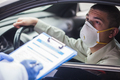 Young man wearing protective face mask in drive-thru Coronavirus car testing center - PhotoDune Item for Sale