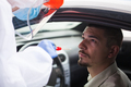 Young male in COVID-19 drive thru mobile testing center having nasal swab taken - PhotoDune Item for Sale