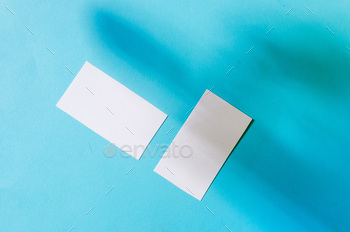ockup template with shadows on blue paper background. Place your design.