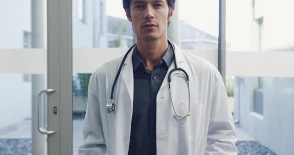 Young male doctor smiling to camera 4k