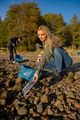 Serious young woman in environment conservation team picking up plastic at beach - PhotoDune Item for Sale