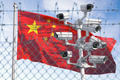 Flag of China behind barbed wire fence and cctv cameras. - PhotoDune Item for Sale