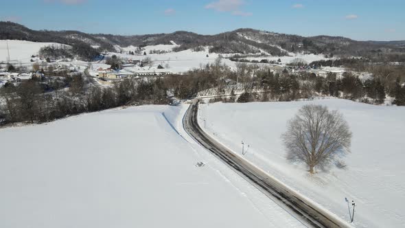 Beautiful sunny winter day in a mountain valley. Animal tracks seen in the smooth snow.