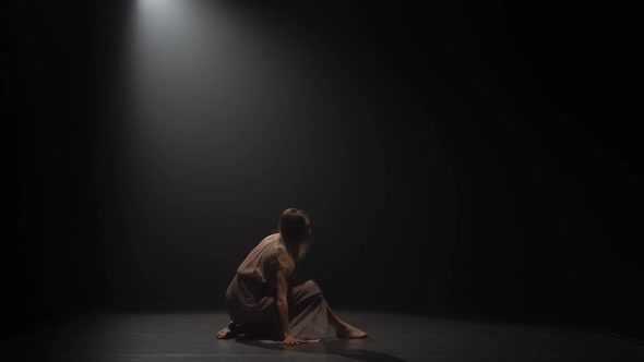 Beautiful Girl Dancing Contemp in Dark Studio Under Spotlight