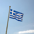 Greece sign symbol. Greek national official flag on flagpole waving in the wind, blue sky - PhotoDune Item for Sale