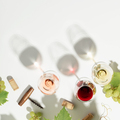 Wine composition with beautiful sunlight and shadows on white background. Top view, flat lay - PhotoDune Item for Sale