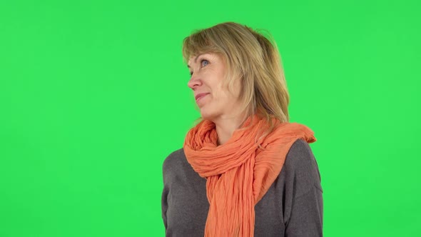 Portrait of Middle Aged Blonde Woman Is Surprised at What Is Happening Around. Green Screen