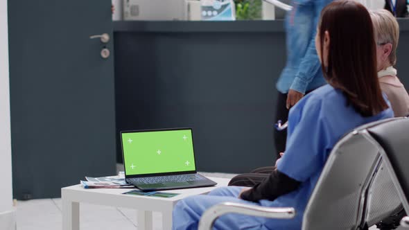 People Sitting in Waiting Area with Greenscreen Template on Laptop