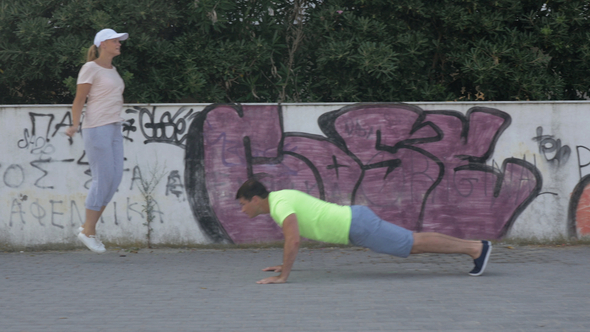 Man and woman training in city street