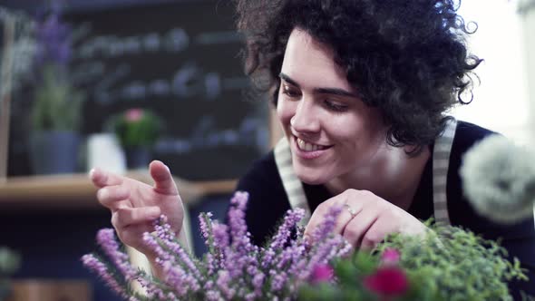 Florist touching soft blossoms of a flower