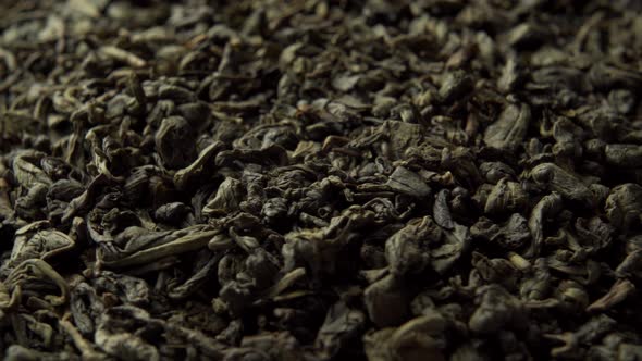 Green Chinese tea gunpowder. Dried coiled leaves close up.