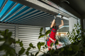 Residential Pergola Installer Performing Final Check on a Newly Built Carport Pergola - PhotoDune Item for Sale