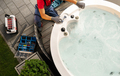 Caucasian Hot Tub Technician Servicing Circular Garden SPA - PhotoDune Item for Sale