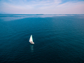 Yacht sailing on opened sea. Aerial view of sailing boat on sea surface. - PhotoDune Item for Sale