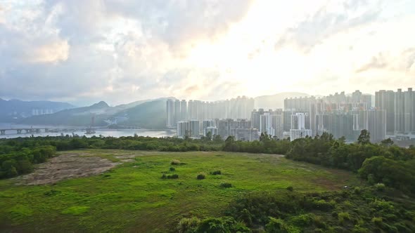 A dynamic aerial footage ascending from the mountains and reveals the cityscape of Tseung Kwan O New