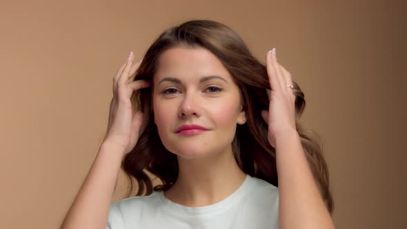 Monochrome Natural Makeup Look Caucasian Woman in Studio with Brunette Wavy Hair Blowing