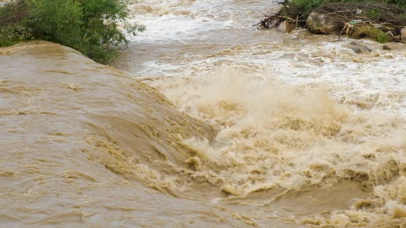 Dirty river with muddy water in flooding period during heavy rains in spring.