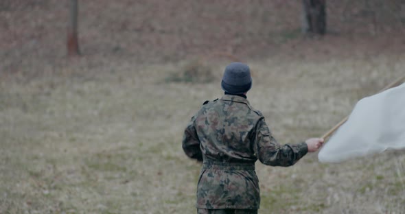 Military Man Waving White Flag During War