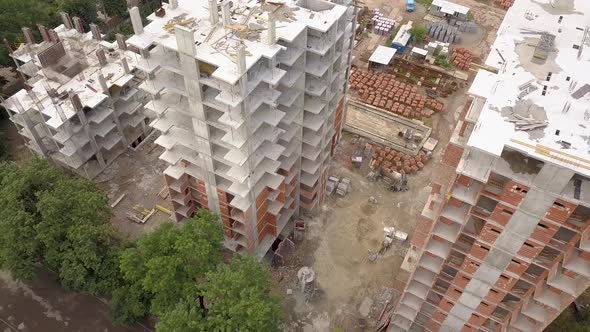 Aerial view of tower crane and residential building under construction.