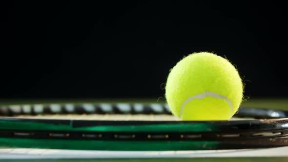 Tennis ball on racket in court