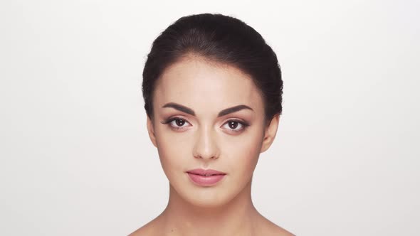 Studio portrait of young and beautiful brunette woman over