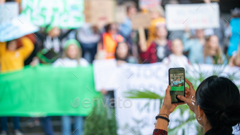 an Holding Phone and Recording Protest.
