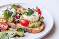Poached eggs, avocado and cherry tomatoes on toast - PhotoDune Item for Sale
