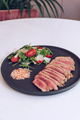 Close up of beef steak with salad on marble table. - PhotoDune Item for Sale