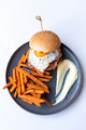 Tasty burger with fried egg served with fried sweet potatoes. - PhotoDune Item for Sale