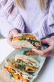 Close up of woman holding tacos. - PhotoDune Item for Sale