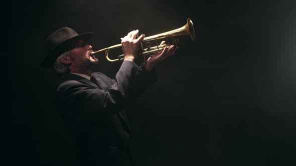 Confident Musician in Hat and Classic Suit Plays Musical Trumpet Presses Condensate Output Key and