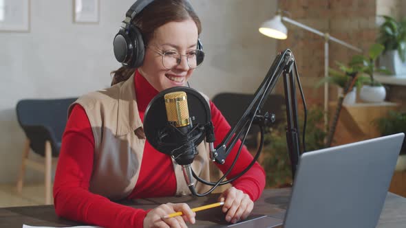 Portrait of Cheerful Female Podcaster in Studio