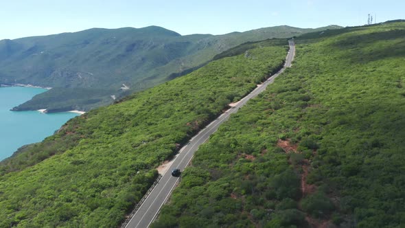 Top View of the Road Stretching Across Steep Hills Covered with Lush Vegetation