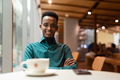Portrait of handsome young black man in coffee shop looking at camera - PhotoDune Item for Sale