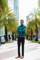Portrait of handsome young black man outdoors in city - PhotoDune Item for Sale