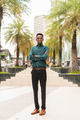 Portrait of handsome young black man outdoors in city - PhotoDune Item for Sale