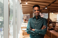Portrait of handsome young black man in coffee shop - PhotoDune Item for Sale