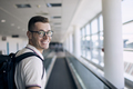 Portrait of smiling traveler at airport - PhotoDune Item for Sale