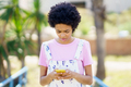 Focused black woman surfing smartphone on street - PhotoDune Item for Sale