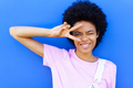 Cheerful black woman making peace sign near wall - PhotoDune Item for Sale