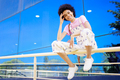 Cheerful black woman sitting on railing - PhotoDune Item for Sale