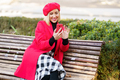 Smiling woman browsing smartphone in park - PhotoDune Item for Sale