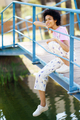 Content black woman sitting on footbridge - PhotoDune Item for Sale