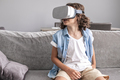 portrait of happy little boy child using virtual reality headset vr glasses gesturing at home fun - PhotoDune Item for Sale