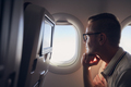 Portrait of man traveling by airplane - PhotoDune Item for Sale
