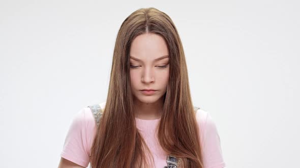 Sad Young Beautiful Girl Looking Down Over White Background